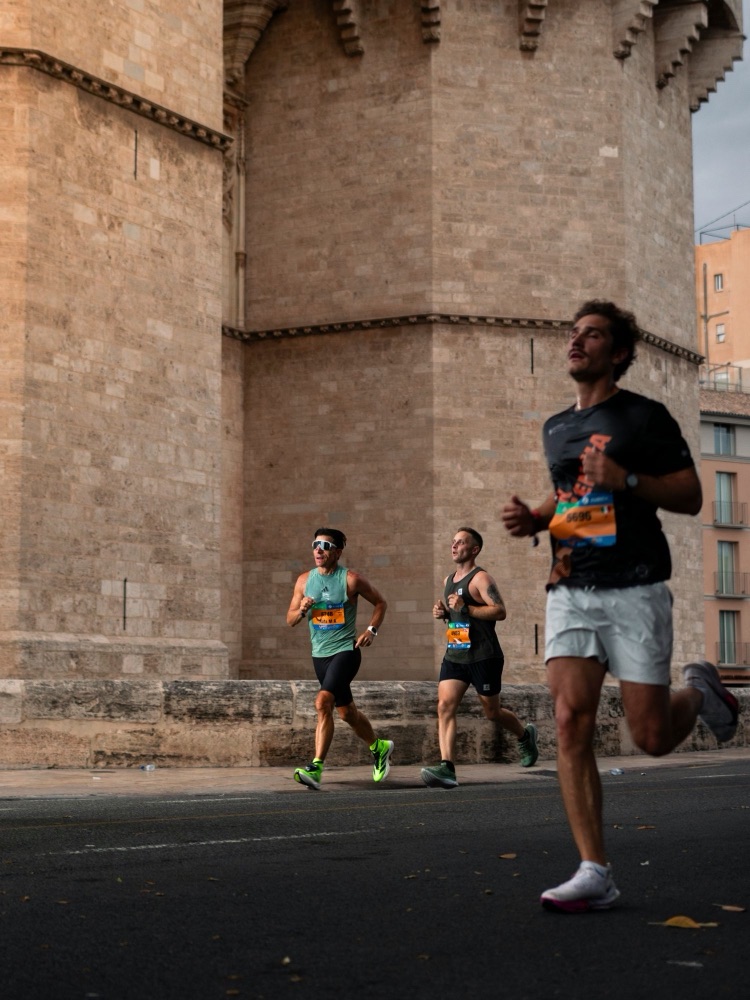 Runners passing an old stone tower